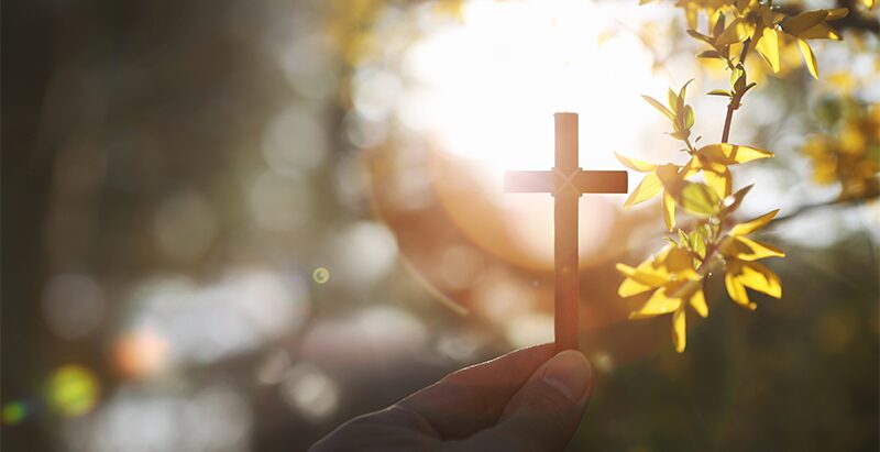 Hands resting together in a moment of faith.
